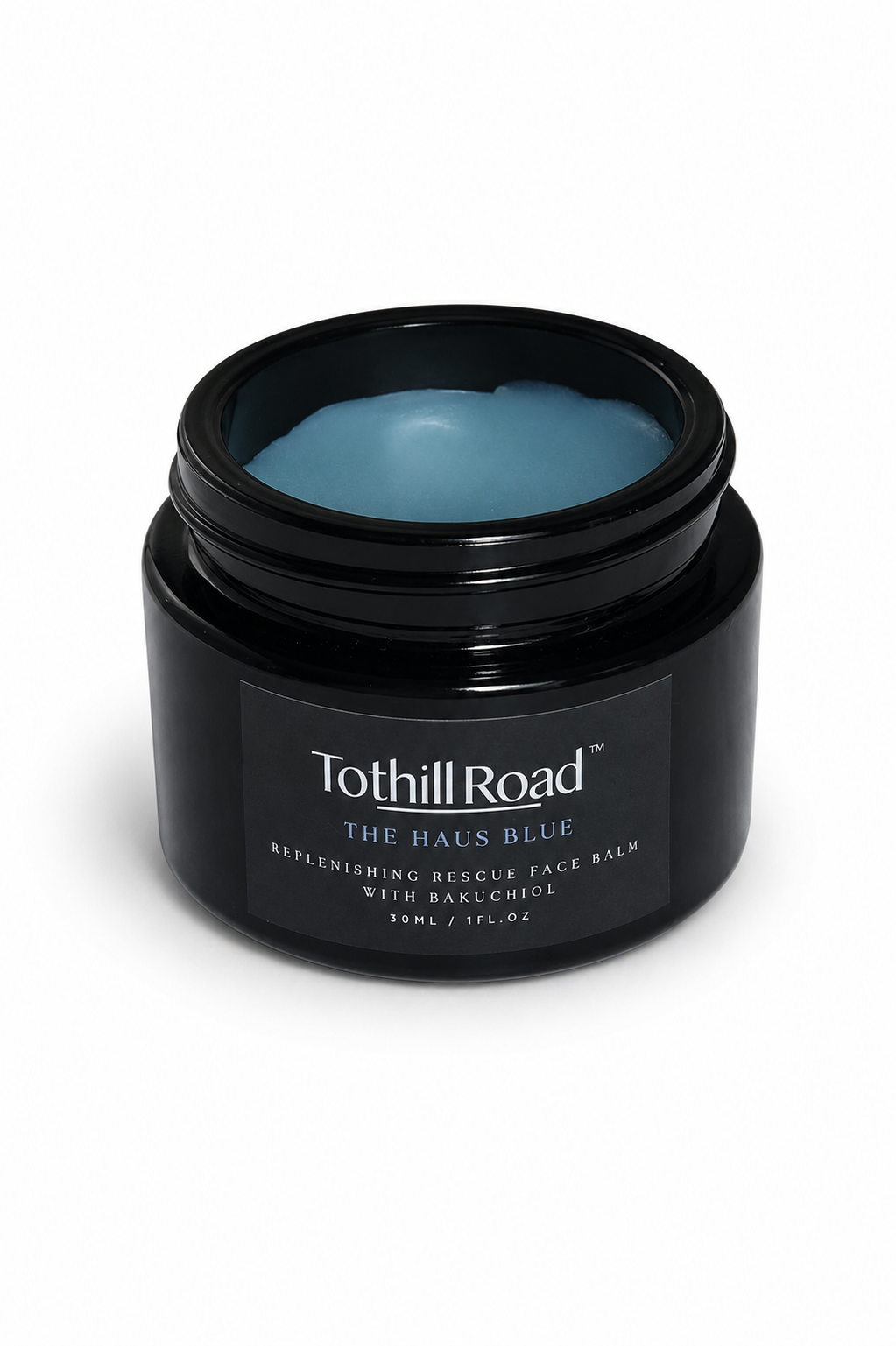 Black jar of Tothill Road face balm on a white background