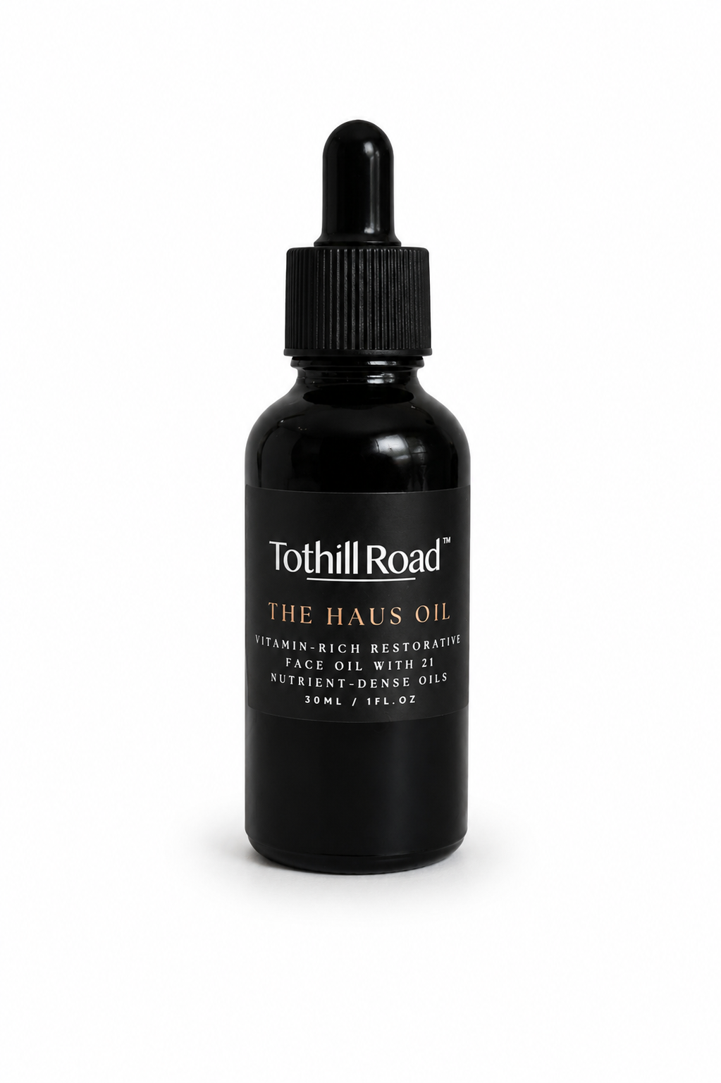 Black bottle of Tothill Road The Haus Oil with dropper on a white background