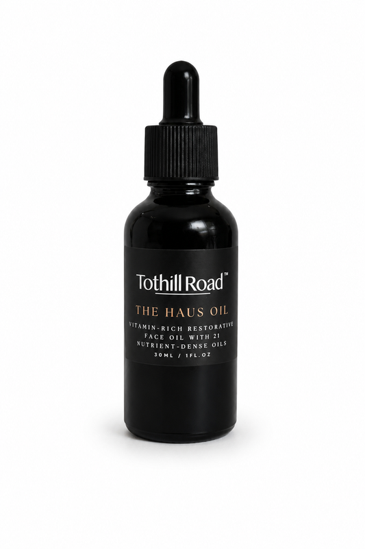 Black bottle of Tothill Road The Haus Oil with dropper on a white background