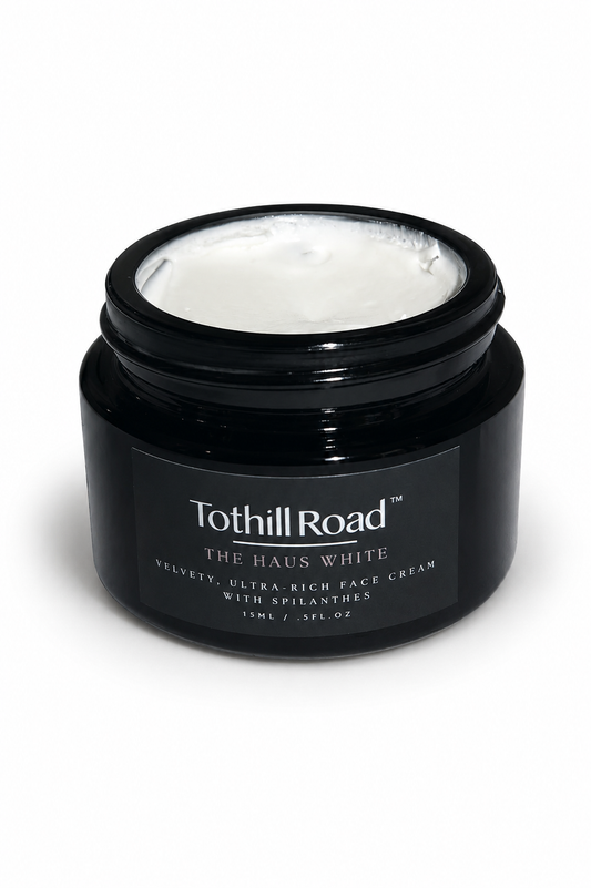 Black jar of Tothill Road Haus White cream on a white background